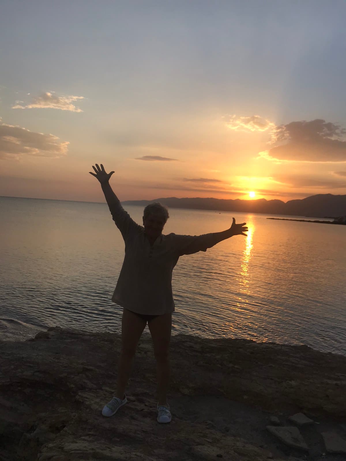 woman doing yoga by the sea