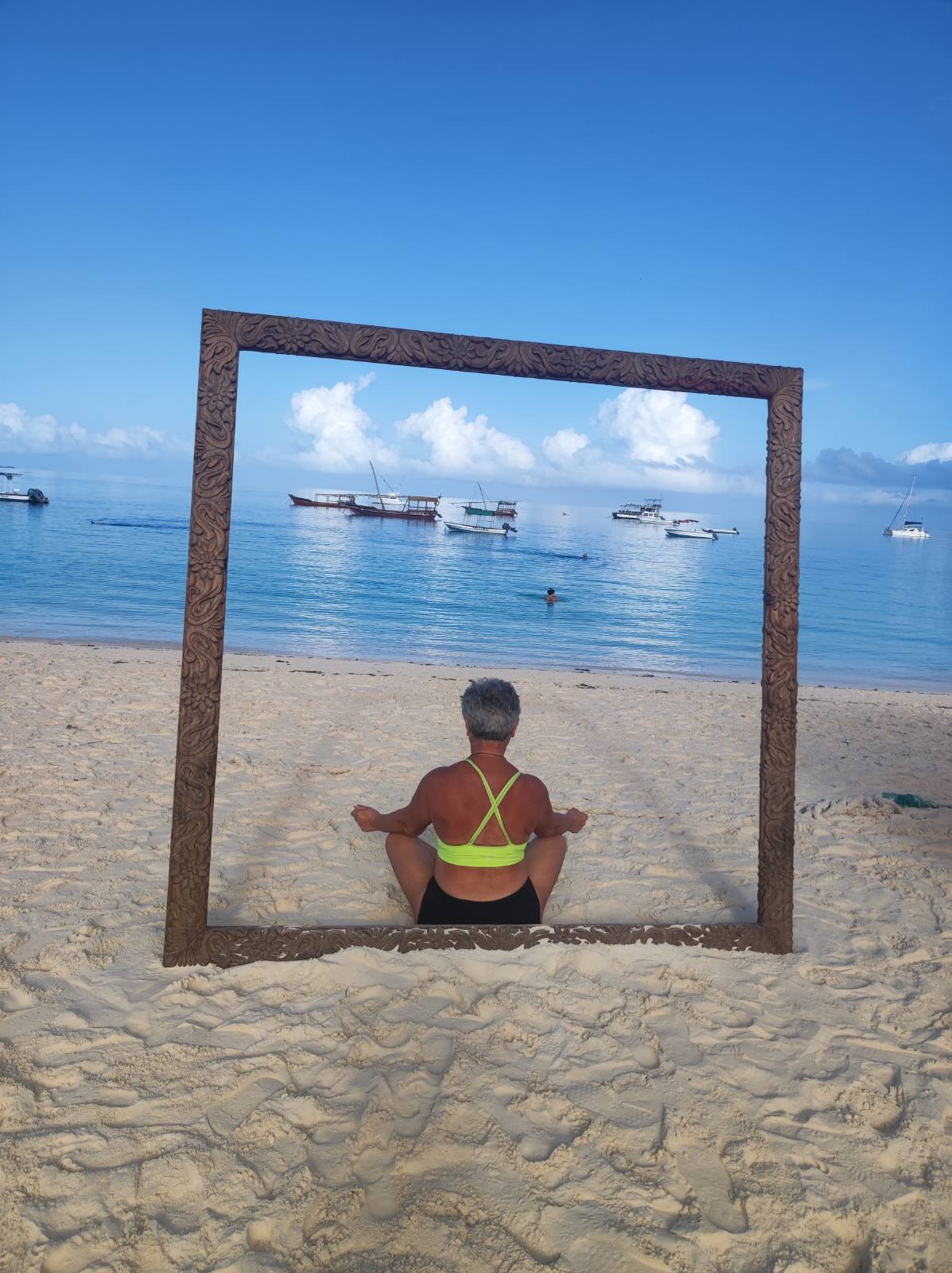 woman doing yoga by the sea